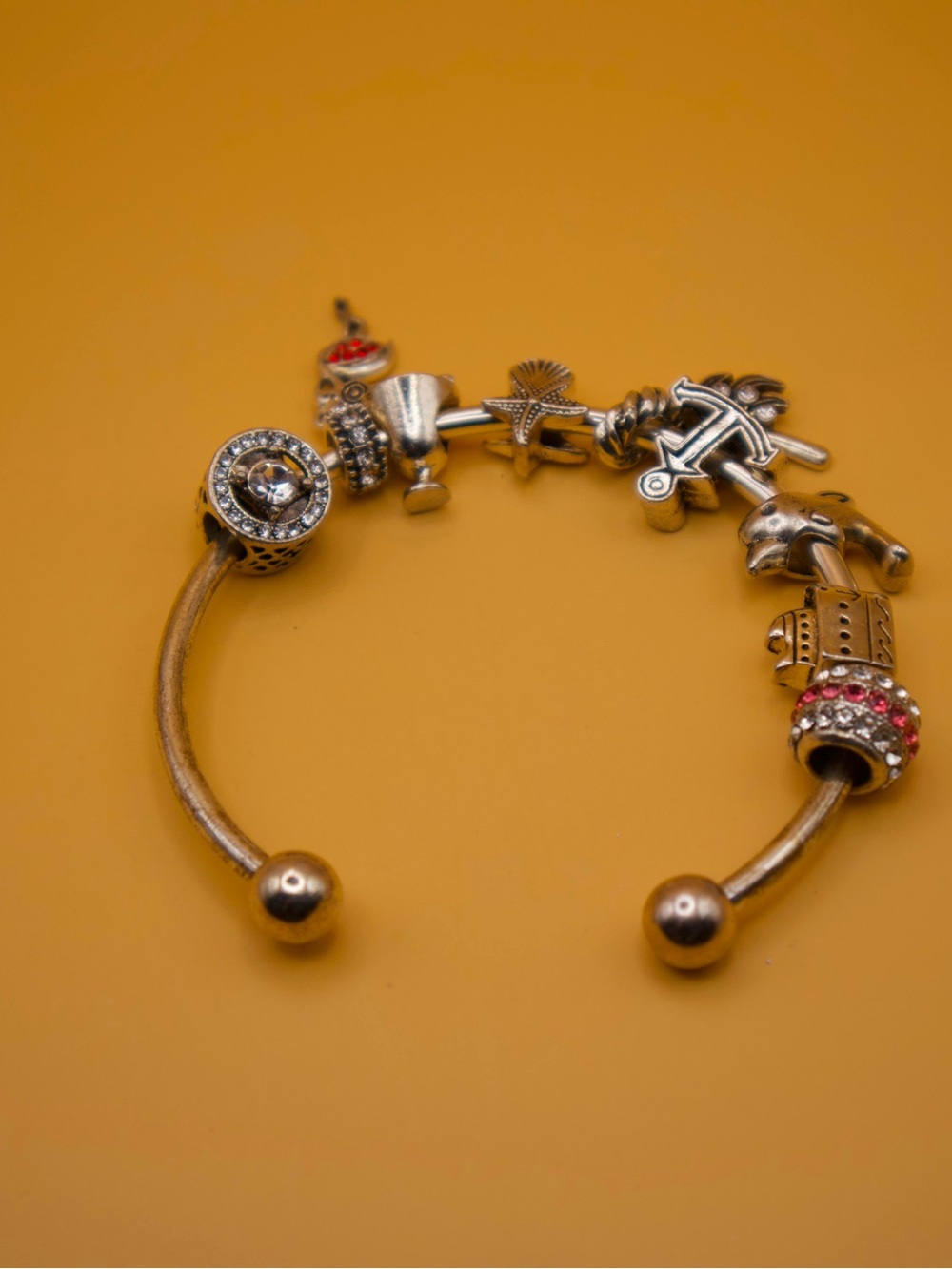 Gold-Tone Charm Bangle Bracelet with Nautical and Decorative Charms
